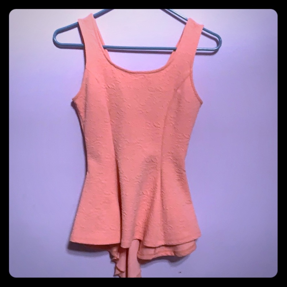 Peach peplum shirt with bow on the back